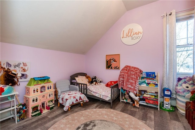 bedroom with lofted ceiling and wood finished floors