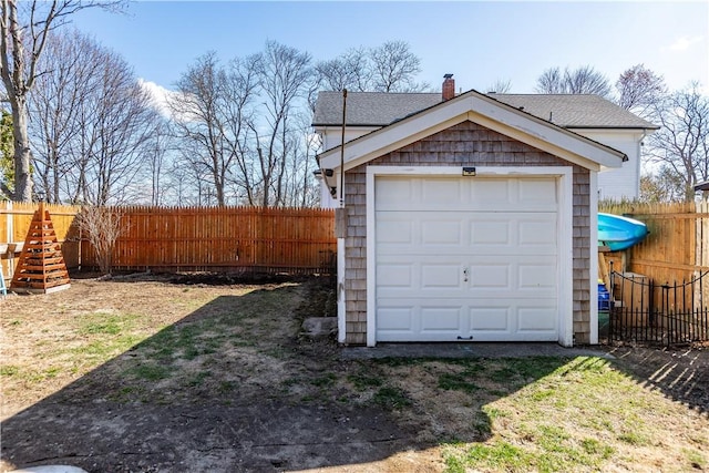 detached garage featuring fence