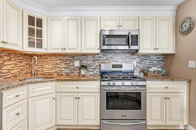 200 Hoffman Ave Unit 405, Cranston, RI 02920 - kitchen with stainless steel appliances, a sink, light stone counters, backsplash, and glass insert cabinets