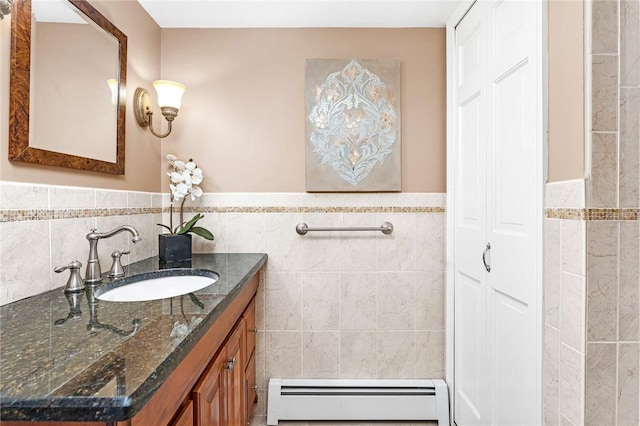 200 Hoffman Ave Unit 405, Cranston, RI 02920 - bathroom featuring a baseboard heating unit, tile walls, vanity, a wainscoted wall, and a closet