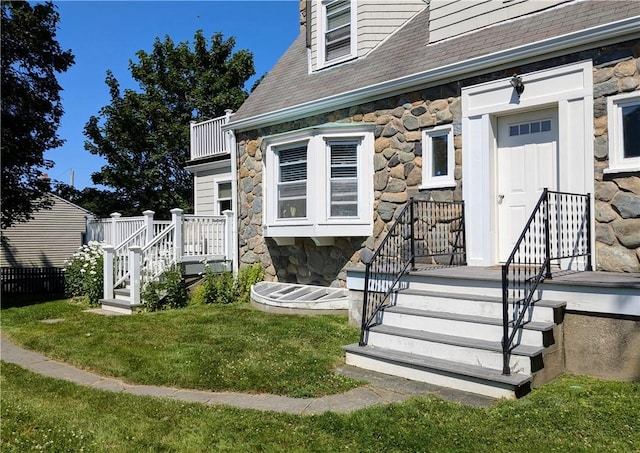 23 Smith Ave Unit 2, Newport, RI 02840 - property entrance featuring a lawn, a shingled roof, and stone siding