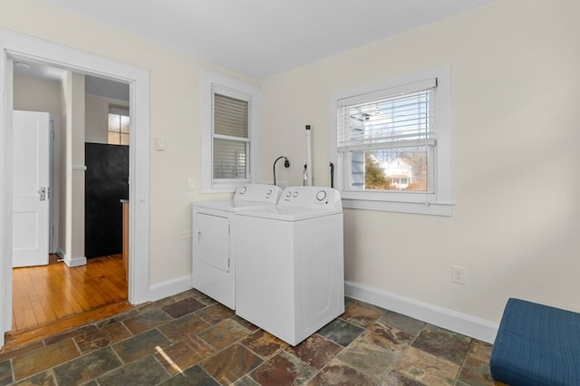 23 Smith Ave Unit 2, Newport, RI 02840 - laundry room featuring baseboards, plenty of natural light, washer and clothes dryer, and stone tile flooring