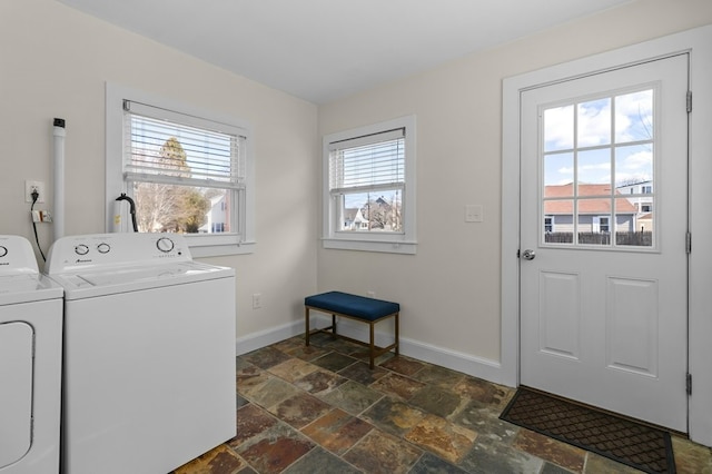 23 Smith Ave Unit 2, Newport, RI 02840 - clothes washing area featuring separate washer and dryer, laundry area, baseboards, and stone tile flooring