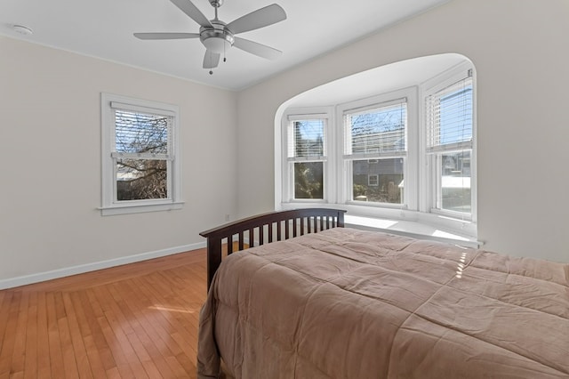 23 Smith Ave Unit 2, Newport, RI 02840 - bedroom featuring baseboards, multiple windows, ceiling fan, and light wood-type flooring