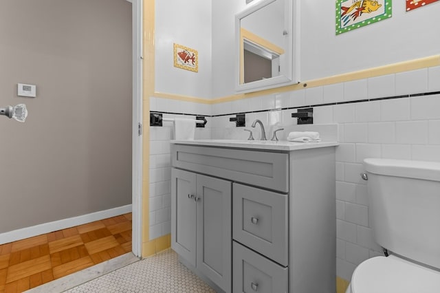 23 Smith Ave Unit 2, Newport, RI 02840 - half bath with wainscoting, vanity, toilet, tile patterned floors, and tile walls