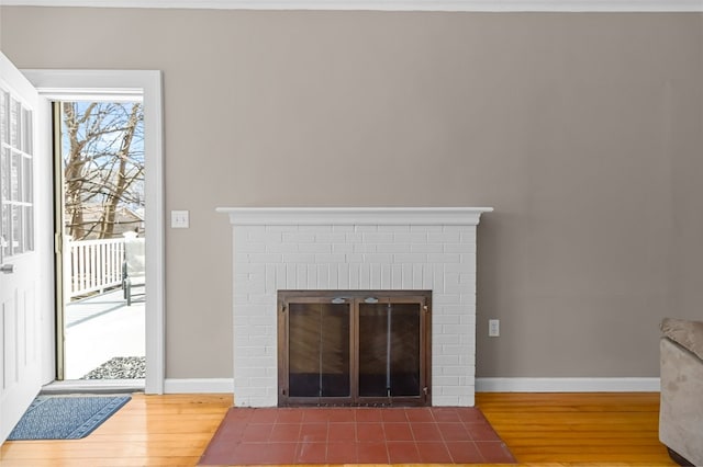 23 Smith Ave Unit 2, Newport, RI 02840 - room details featuring a brick fireplace, baseboards, and wood finished floors