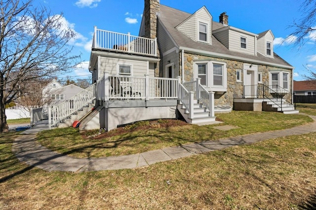 23 Smith Ave Unit 2, Newport, RI 02840 - view of front of property featuring a chimney, a balcony, a front lawn, stairs, and stone siding
