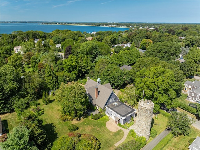 aerial view with a water view and a wooded view