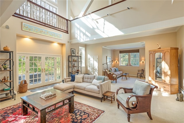 living area with french doors, crown molding, a towering ceiling, and carpet flooring