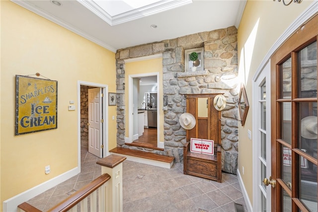 corridor with baseboards, french doors, tile patterned floors, and crown molding