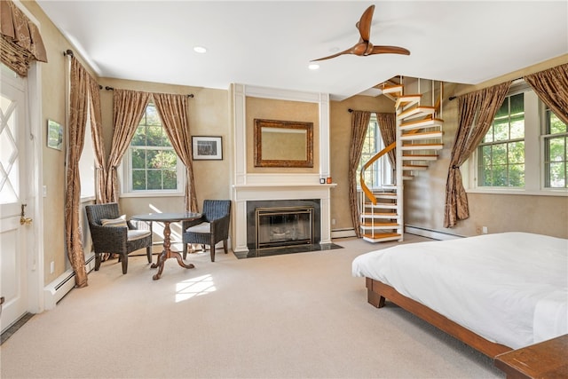 bedroom featuring a baseboard radiator, a fireplace with flush hearth, carpet, and recessed lighting