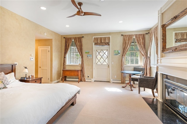 carpeted bedroom featuring a fireplace with flush hearth, baseboard heating, baseboards, ceiling fan, and recessed lighting