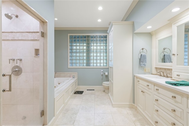 bathroom with toilet, vanity, a jetted tub, and a shower stall