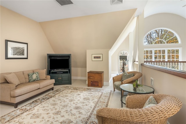 living room with carpet, baseboards, vaulted ceiling, and visible vents