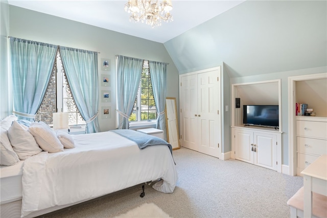 carpeted bedroom featuring baseboards, lofted ceiling, a notable chandelier, and a closet