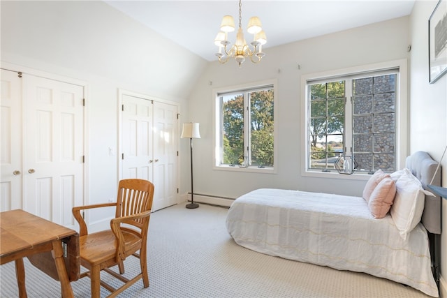 bedroom featuring a notable chandelier, vaulted ceiling, carpet floors, two closets, and a baseboard heating unit