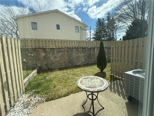 view of yard featuring a fenced backyard and central AC unit