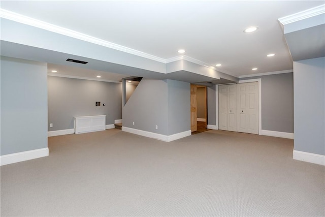 finished below grade area with recessed lighting, baseboards, light colored carpet, and ornamental molding