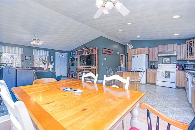 dining space with a ceiling fan, lofted ceiling, and recessed lighting
