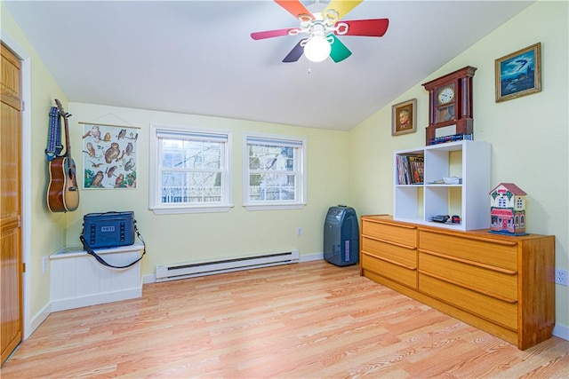 interior space with light wood-type flooring, a ceiling fan, a baseboard heating unit, and vaulted ceiling