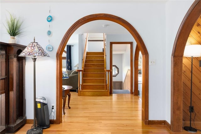 135 Eagleville Rd, Tiverton, RI 02878 - hall with arched walkways, light wood-style flooring, stairway, and baseboards