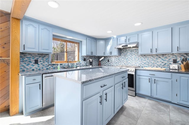 135 Eagleville Rd, Tiverton, RI 02878 - kitchen featuring appliances with stainless steel finishes, under cabinet range hood, backsplash, light stone countertops, and recessed lighting