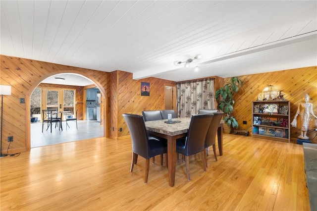 135 Eagleville Rd, Tiverton, RI 02878 - dining space with arched walkways, wood walls, light wood finished floors, wooden ceiling, and french doors