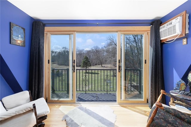135 Eagleville Rd, Tiverton, RI 02878 - doorway to outside featuring plenty of natural light, wood finished floors, and a wall unit AC
