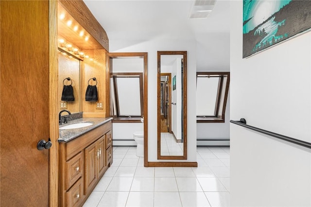 135 Eagleville Rd, Tiverton, RI 02878 - full bath with a baseboard radiator, vanity, toilet, and tile patterned flooring