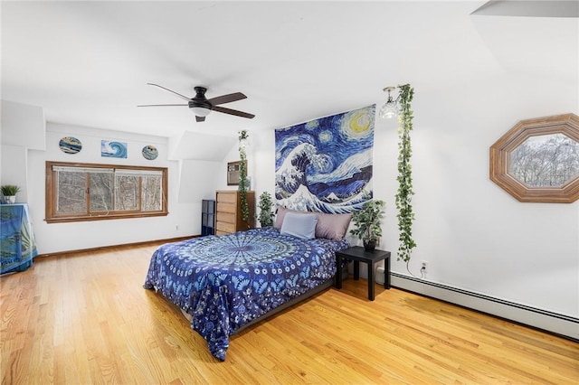 135 Eagleville Rd, Tiverton, RI 02878 - bedroom with a baseboard heating unit, wood finished floors, vaulted ceiling, and ceiling fan