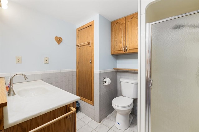135 Eagleville Rd, Tiverton, RI 02878 - full bathroom with tile walls, tile patterned flooring, a shower stall, toilet, and a wainscoted wall