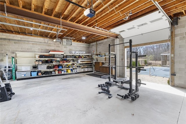 135 Eagleville Rd, Tiverton, RI 02878 - garage with a garage door opener and concrete block wall