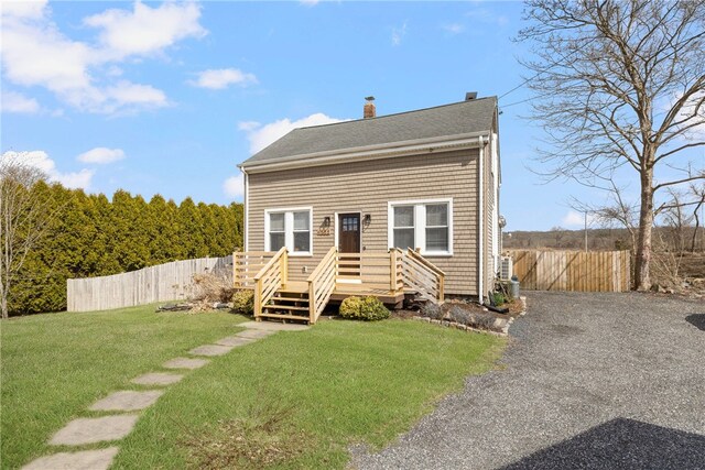 4588 Main Rd, Tiverton, RI 02878 - view of front of house featuring a chimney, fence, and a front yard
