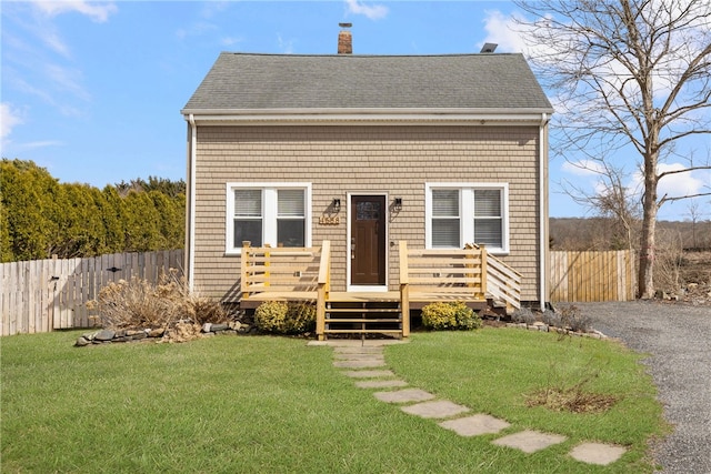 4588 Main Rd, Tiverton, RI 02878 - view of front facade featuring a chimney, fence, and a front lawn
