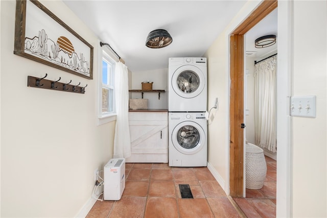 4588 Main Rd, Tiverton, RI 02878 - clothes washing area featuring tile patterned floors, stacked washer and clothes dryer, laundry area, baseboards, and visible vents