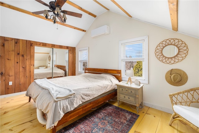 4588 Main Rd, Tiverton, RI 02878 - bedroom with a wall mounted AC, hardwood / wood-style flooring, baseboards, ceiling fan, and lofted ceiling