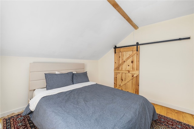 4588 Main Rd, Tiverton, RI 02878 - bedroom featuring baseboards, lofted ceiling with beams, a barn door, and wood finished floors