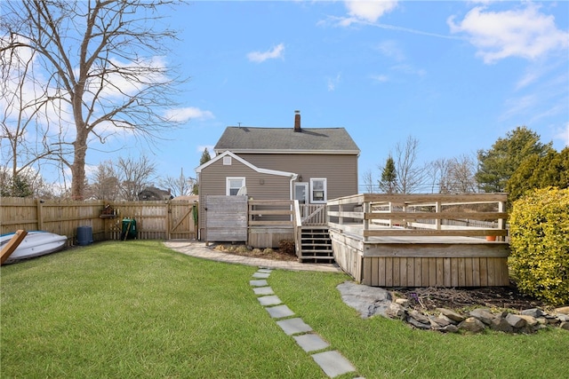 4588 Main Rd, Tiverton, RI 02878 - back of property with a gate, a chimney, a deck, fence, and a lawn