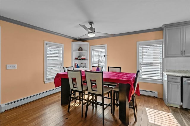 dining room with a ceiling fan, baseboard heating, crown molding, and hardwood / wood-style floors