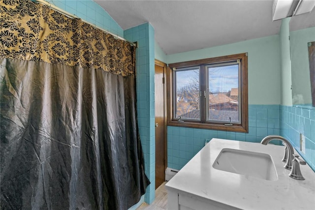 bathroom featuring a baseboard radiator, a shower with shower curtain, vanity, and tile walls