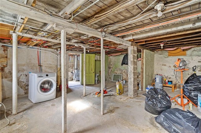 unfinished basement featuring washer / dryer