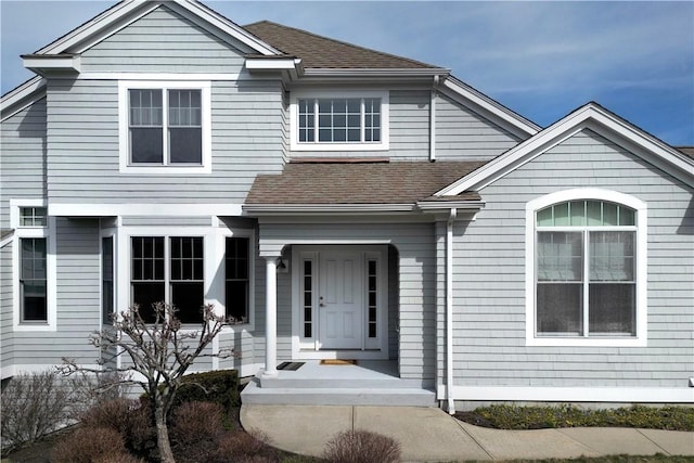 view of front of home with a shingled roof