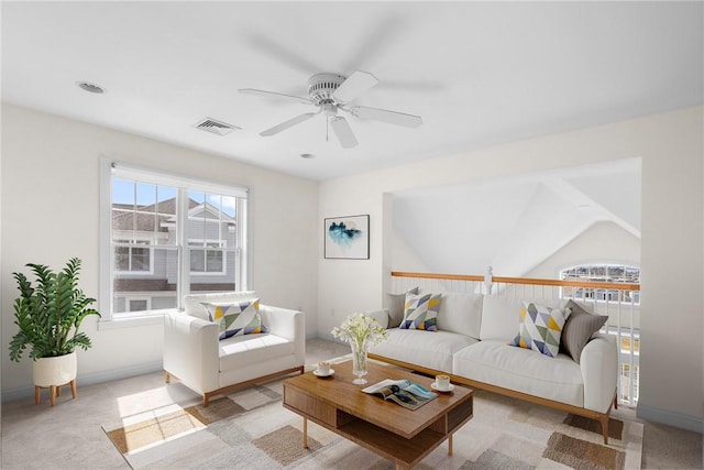 living area with plenty of natural light, visible vents, light carpet, and ceiling fan