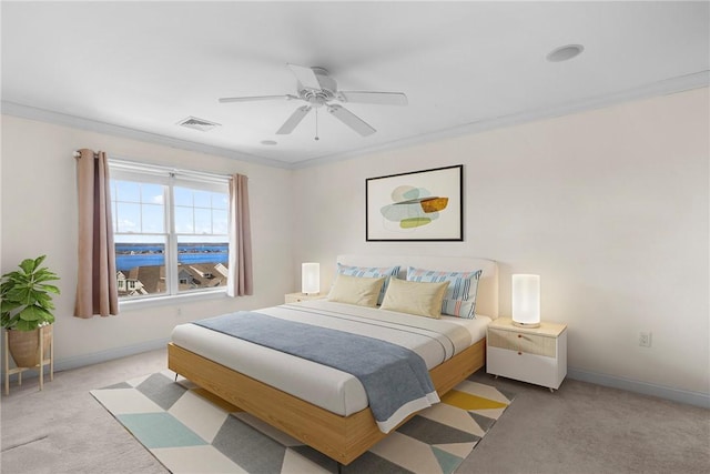 bedroom featuring baseboards, visible vents, crown molding, and carpet flooring