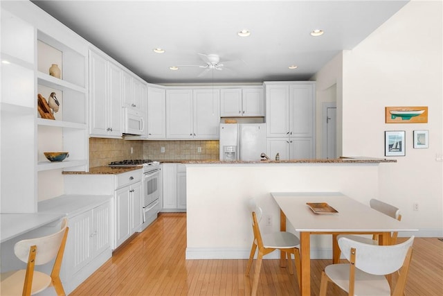 kitchen with white cabinetry, a ceiling fan, light wood-style flooring, and white appliances