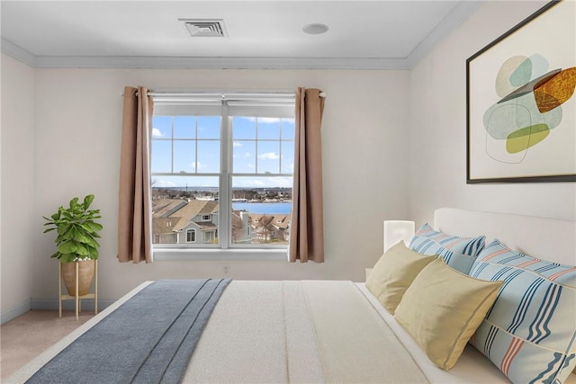 carpeted bedroom with baseboards, visible vents, and ornamental molding