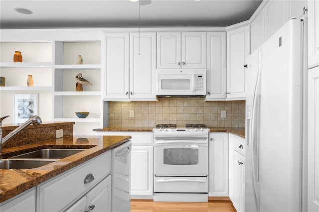 kitchen with white cabinetry, a sink, open shelves, and white appliances