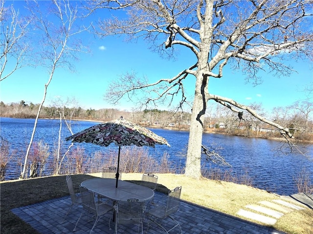 dock featuring a water view, a patio area, and outdoor dining area