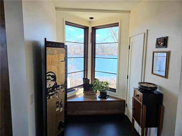 doorway featuring a water view and baseboards