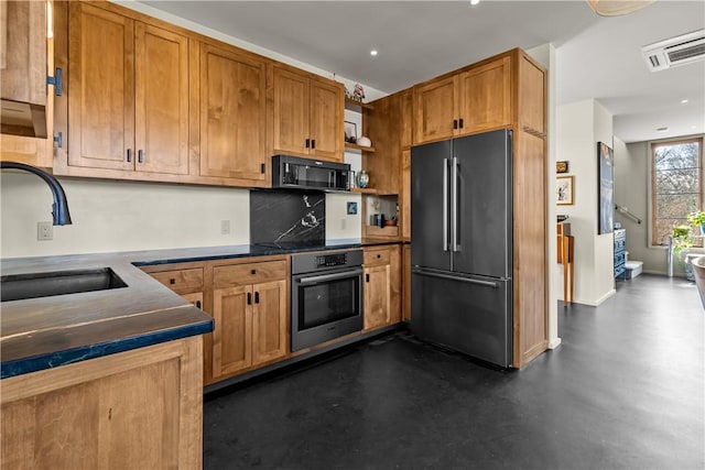 kitchen with black appliances, a sink, decorative backsplash, dark countertops, and recessed lighting